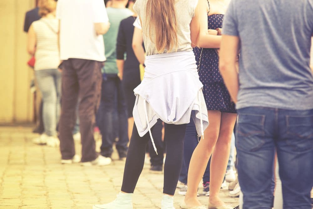 People standing together in a line outdoors, representing a local community gathering and potential local followers for salons.