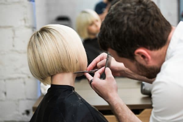 Hair dresser cutting clients hair