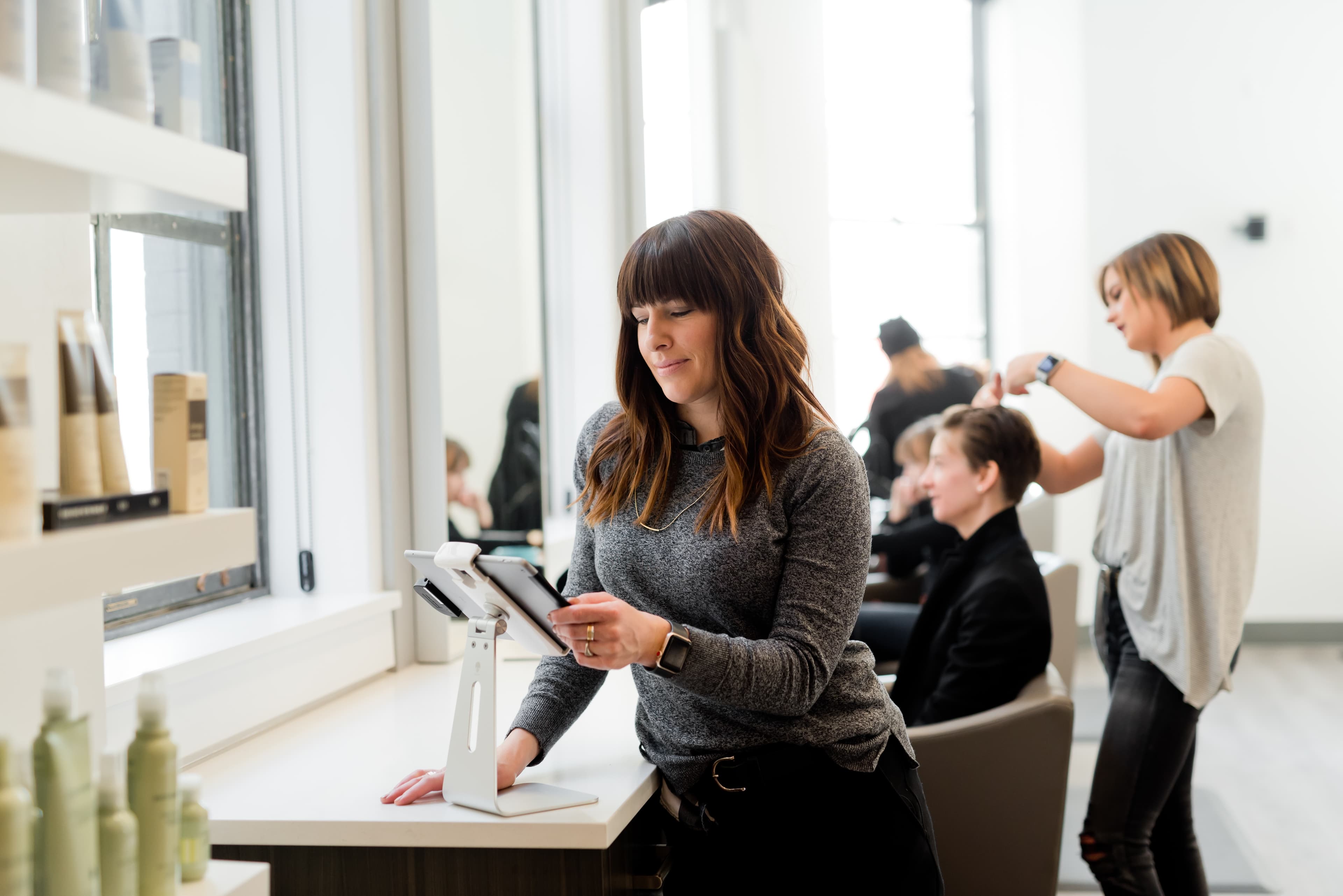 Hair stylist using tablet