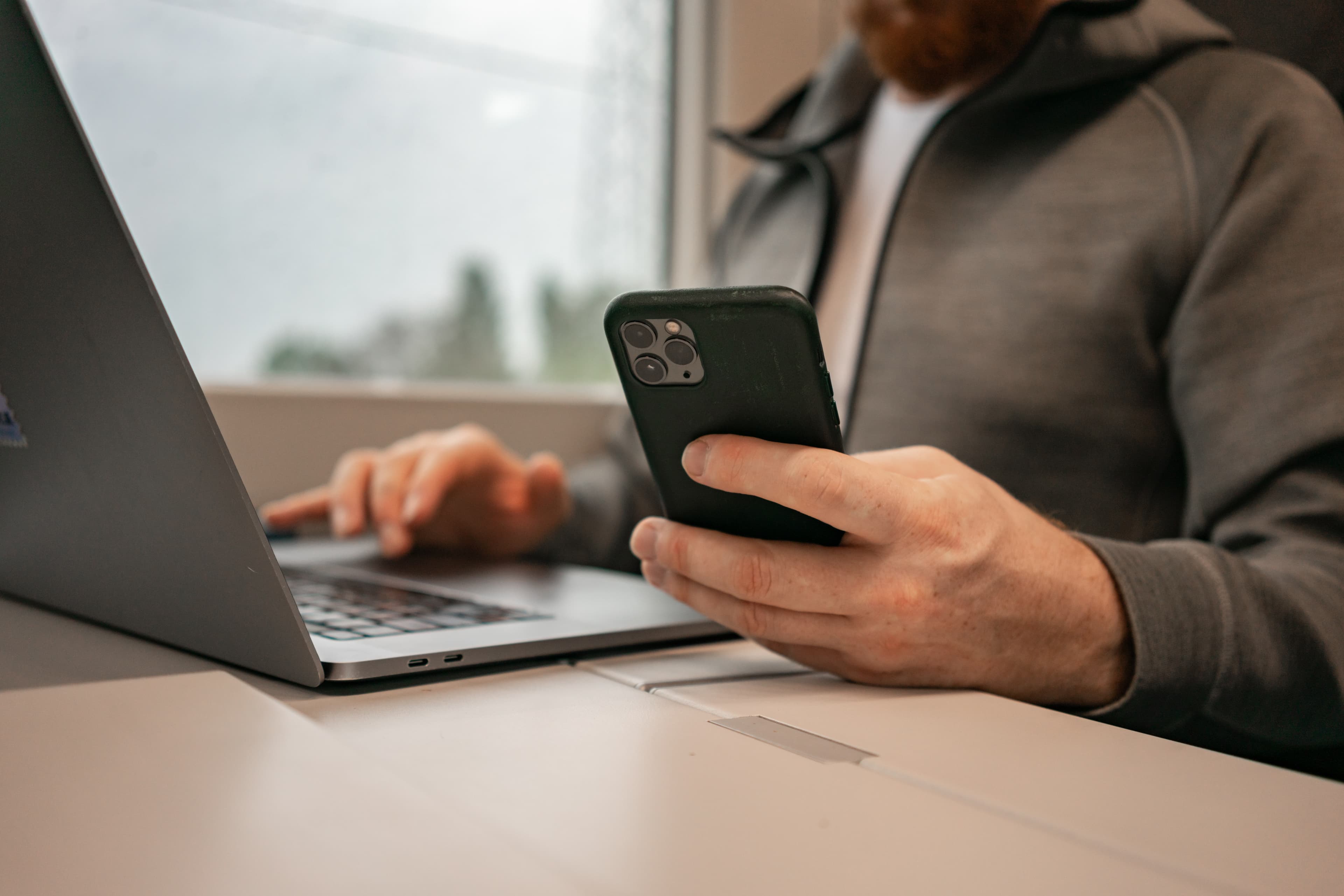 Person using laptop and phone