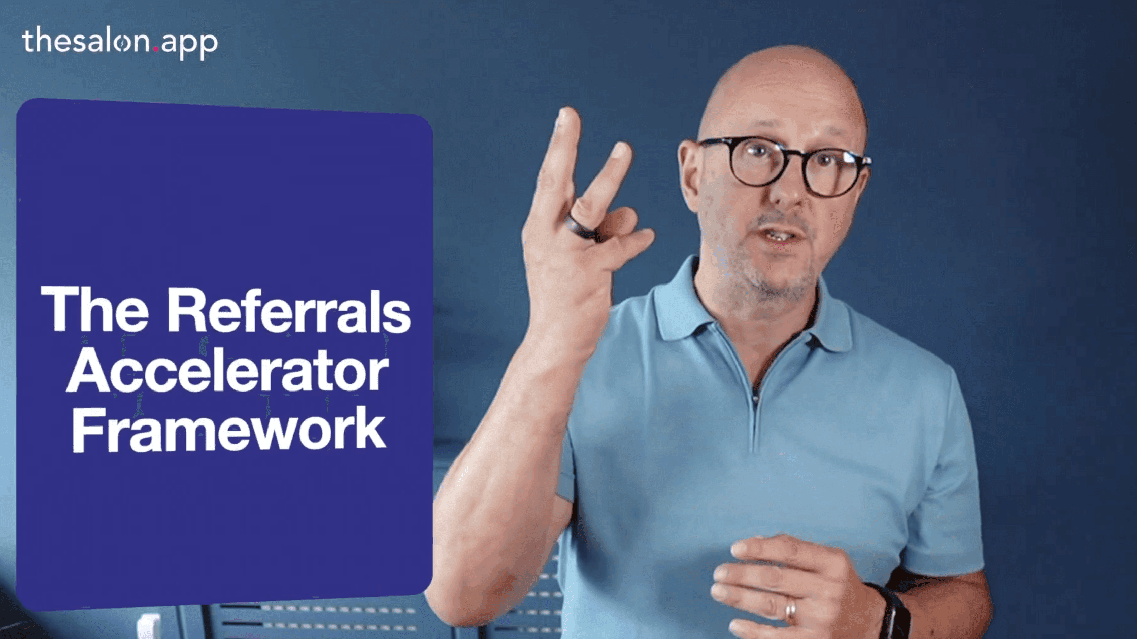 "The Referrals Accelerator Framework" for salon businesses. He gestures with three fingers, emphasizing key points in a video from The Salon App. A deep blue background and branded text overlay reinforce the professional and engaging style.